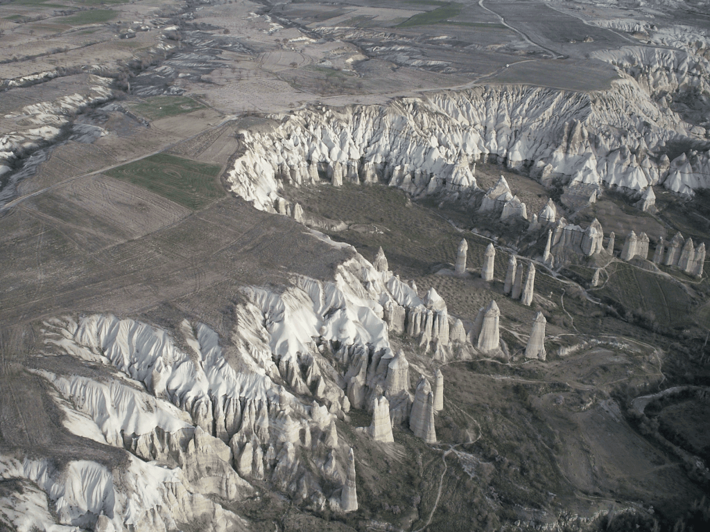 Simulated annealing algorithms work to find the optimal solution in a “landscape” of peaks and valleys representing different costs. (Cappadocia, Turkey. Photo by Frank and Rosalind Reinhard)