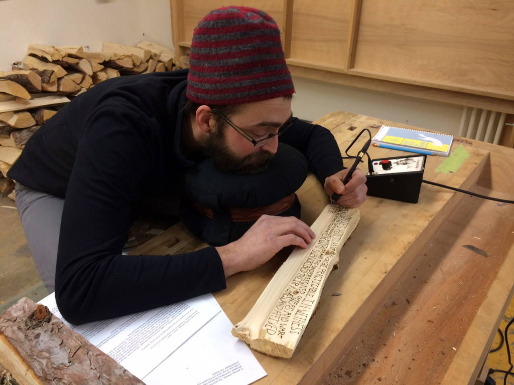 Benjamin Wooten at work in the studio burning the 1816 Treaty with the Winnebago into pine. Photo by Tom Loeser.