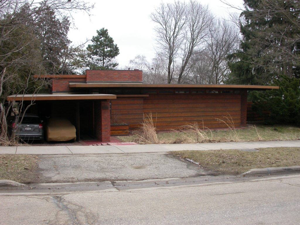 Fig. 6. Exterior view of the first Usonian house, the first Herb and Katherine Jacobs House (1936) in Madison. Wright’s emphasis on the automobile is shown with the dominant carport (left). The house is deliberately oriented away from the street, with the front room being lit by the narrow band of ribbon windows across the façade. Photo by author, April, 2012.