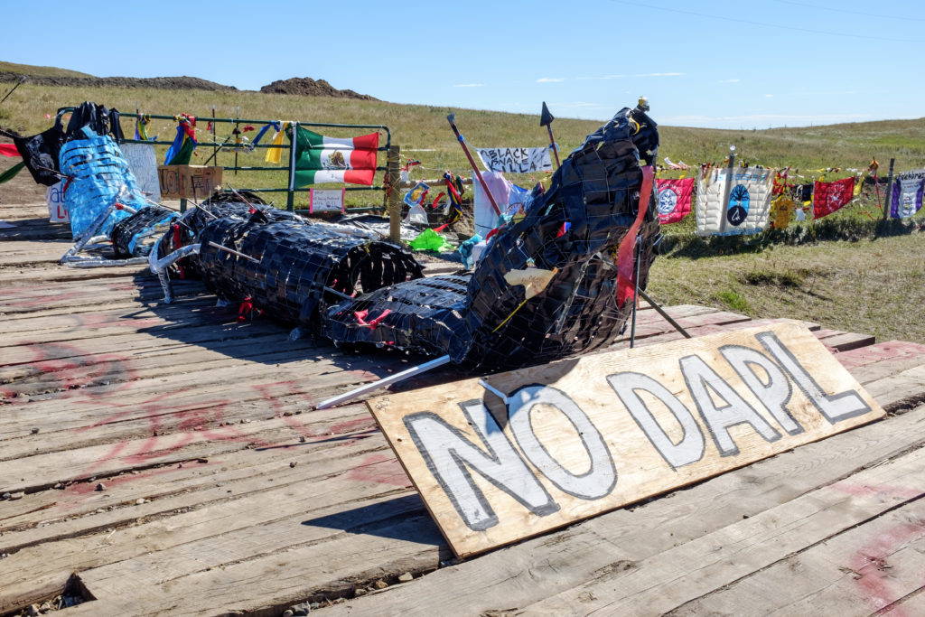 Activists at the Red Warrior Camp produced this sculpture, titled “Black Snake Killa,” which evokes a Lakota story of an apocalyptic black snake. The snake has been placed here, at one of the active construction sites, along with banners and signs declaring solidarity from tribes, communities, and social movements from around the world. Image by author, September 2016.