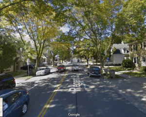 Look near to see far. What might this tree-lined street in Madison, Wisconsin reveal about similar neighborhoods around the country? Image: Google Maps.