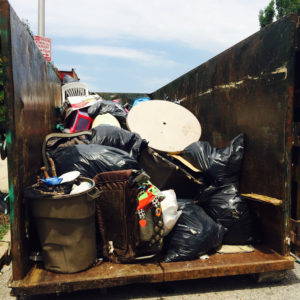 A nearly full dumpster at an intervention in which the research team and community partners cleared garbage from just two blocks in Baltimore. Photo by Dawn Biehler, 2016.