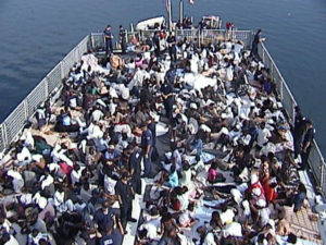 Deck of the U.S. Coast Guard Cutter Legare with 301 Haitian migrants rescued on the Caribbean Sea in 2001. Image from Wikimedia Commons.