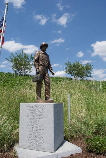 A monument to the 52 munitions workers who perished in an explosion on June 5, 1942, stands on former arsenal land near the entrance to the Abraham Lincoln National Cemetery in Elwood, IL. Photo by Sean Thoel, 2017.
