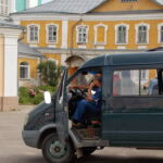A construction worker waits outside the cathedral. Many of the old roads are cobblestone and are in disrepair, making travel difficult. (Conti, 2014) A construction worker waits outside the cathedral. Many of the old roads are cobblestone and are in disrepair, making travel difficult. (Conti, 2014)
