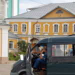 A construction worker waits outside the cathedral. Many of the old roads are cobblestone and are in disrepair, making travel difficult. (Conti, 2014) A construction worker waits outside the cathedral. Many of the old roads are cobblestone and are in disrepair, making travel difficult. (Conti, 2014)