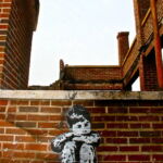 The graffiti artist Banksy has left his signature trace: a forlorn child hugging his knees. (December 2012) The graffiti artist Banksy has left his signature trace: a forlorn child hugging his knees. (December 2012)
