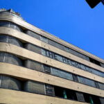 A view from New York Avenue of the northwest corner of the Hecht Company Warehouse, built in 1937. The alternating bands of glass block and glazed brick, the rounded “streamlined” corners, and the glass block crown have made the building a celebrated example of Art Deco architectural design. (Rebecca Summer, 2014) A view from New York Avenue of the northwest corner of the Hecht Company Warehouse, built in 1937. The alternating bands of glass block and glazed brick, the rounded “streamlined” corners, and the glass block crown have made the building a celebrated example of Art Deco architectural design. (Rebecca Summer, 2014)