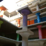 Light streams into a newly-cut interior courtyard at the Hecht Company Warehouse. The concrete columns will remain as part of the new space’s industrial aesthetic. The bright paint is left over from this area’s days as a storage space; each color indicated a different storage function. (Rebecca Summer, 2014) Light streams into a newly-cut interior courtyard at the Hecht Company Warehouse. The concrete columns will remain as part of the new space’s industrial aesthetic. The bright paint is left over from this area’s days as a storage space; each color indicated a different storage function. (Rebecca Summer, 2014)