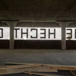 A view of the east-facing letters, H-E-C-H-T C-O, taken from the interior of the Hecht Company Warehouse’s fifth floor. The glazed brick letters are embedded in the glass block walls. (Rebecca Summer, 2014) A view of the east-facing letters, H-E-C-H-T C-O, taken from the interior of the Hecht Company Warehouse’s fifth floor. The glazed brick letters are embedded in the glass block walls. (Rebecca Summer, 2014)