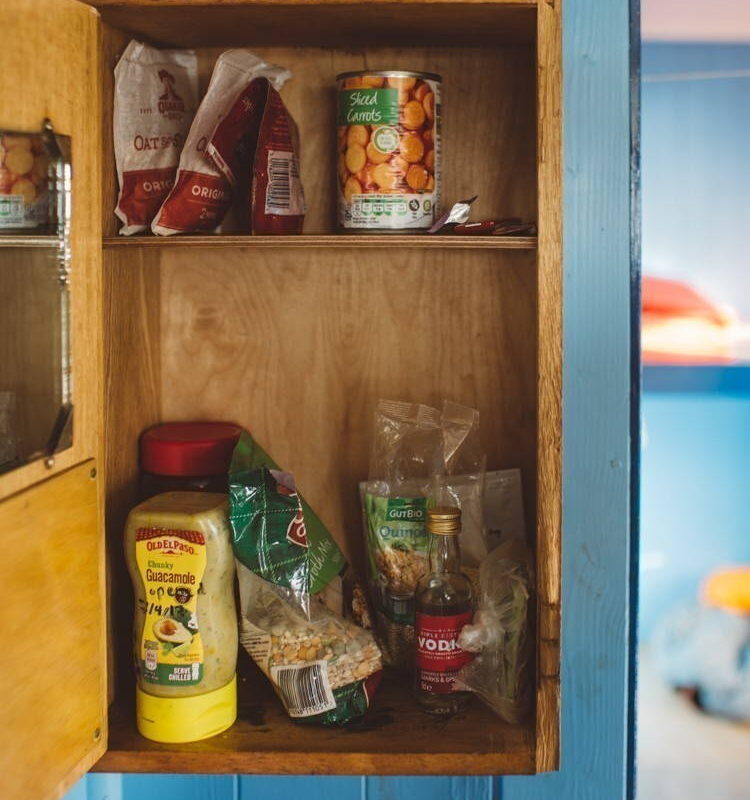 The Lookout, 2017. Canned food sits in a cabinet.