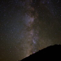 Stars fill the night sky. The Bears Ears region has some of the lowest levels of light pollution in the United States. A photograph of the nighttime starts.
