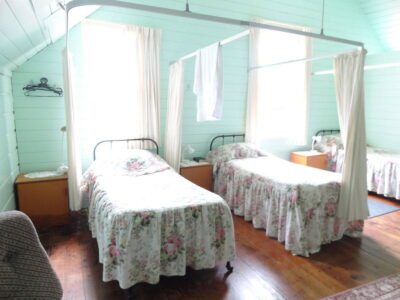 The dormitory and other buildings of the church at Jerusalem attract visitors. Several beds in a brightly painted room