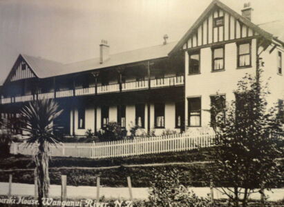 For tourists driving the river road, the trip ends at Pipiriki, a former pleasure destination. The old hotel still stands. A black and white photograph of a building