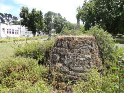 Whanganui also hosts several civic monuments, some now contested because of their link to the colonial past. A pedastel overgrown with weeds with a statue visible in the background