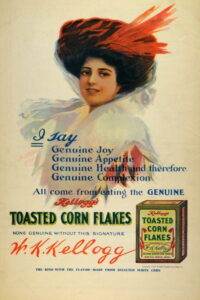 An advertisement for Kelloggs' Corn Flakes, circa 1910, features a white woman and promises of "genuine joy, appetite, health, and complexion." Portrait of a woman with a large hat and a box of corn flakes.
