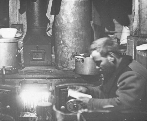 A member of Ernest Shackleton's 1914 expedition reads while on board the Endurance. Photograph from Wikimedia Commons.