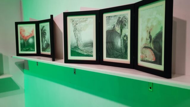 Installation of triptychs in Quiet as drawings exhibit. Photograph by David Cave, 2021. Drawings placed in photo frames and placed on shelf