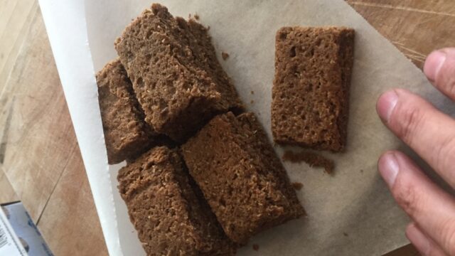 Experimenting with Kernza flour results in maple Kernza shortbread. Photo by the author, 2021. rectangular brown pastries stacked on parchment paper