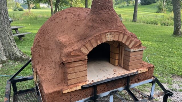 The mobile ARK oven awaiting its final, decorative clay layer. Photo by the author, 2022. Outdoor oven made of clay and brick
